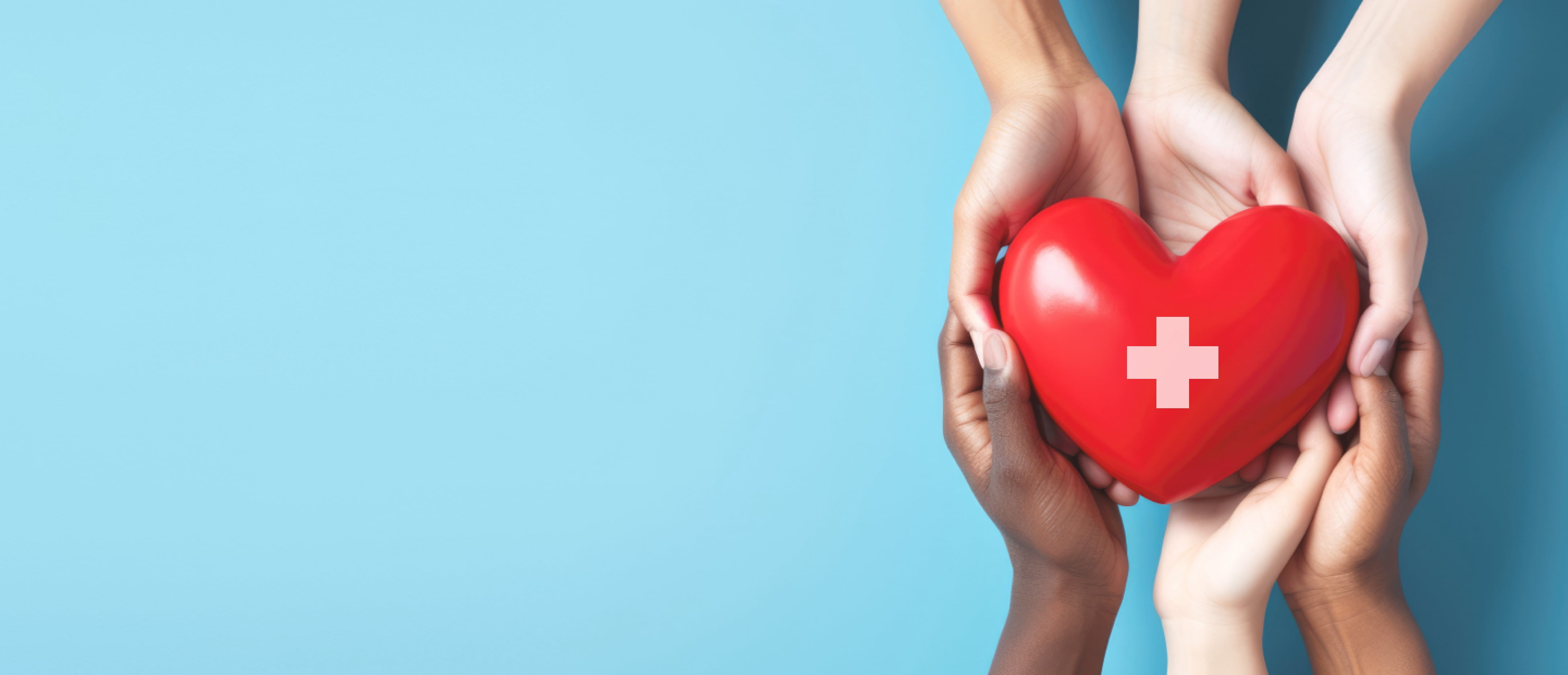 Hands holding a symbolic heart with the sign of medical services
