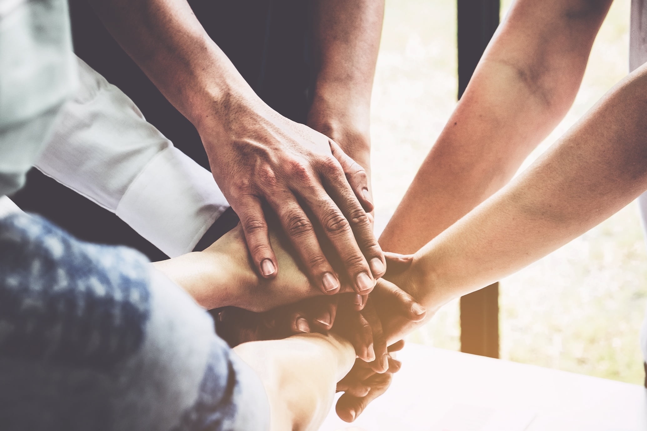 Hands folded on top of each other in a gesture of solidarity